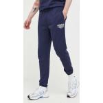 Pánske Športové nohavice Tommy Hilfiger TOMMY JEANS tmavo modrej farby s jednofarebným vzorom z bavlny vo veľkosti XXS v zľave 