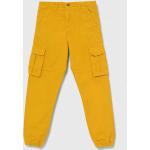 Chlapčenské Detské nohavice Guess žltej farby s jednofarebným vzorom z bavlny 