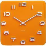 Nástenné hodiny Karlsson oranžovej farby zo skla 